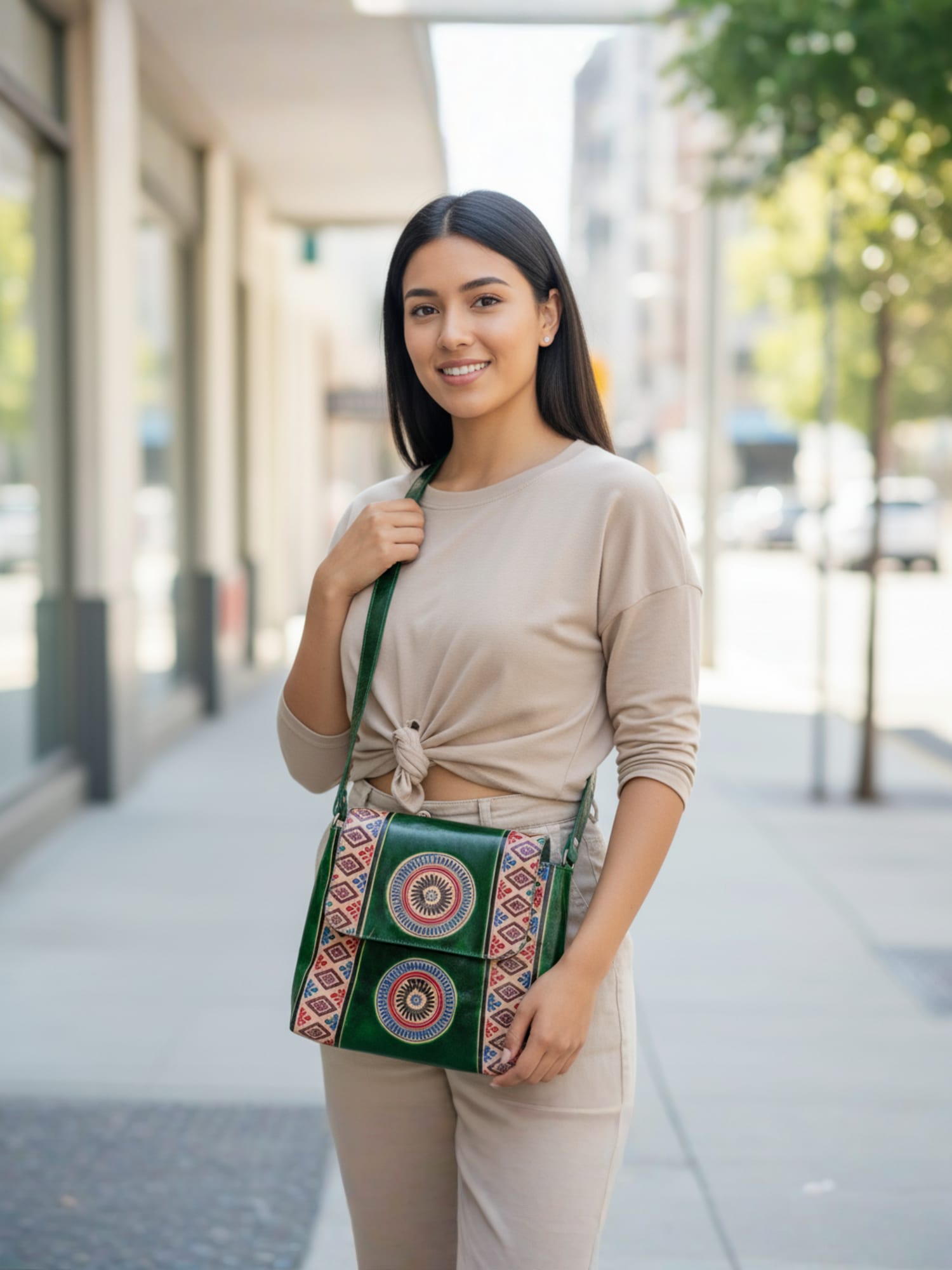 Woman holding a green patterned handbag on a city street