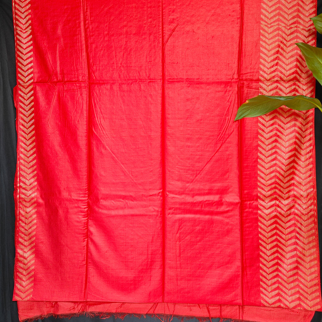 Red fabric with white geometric patterns on a black background