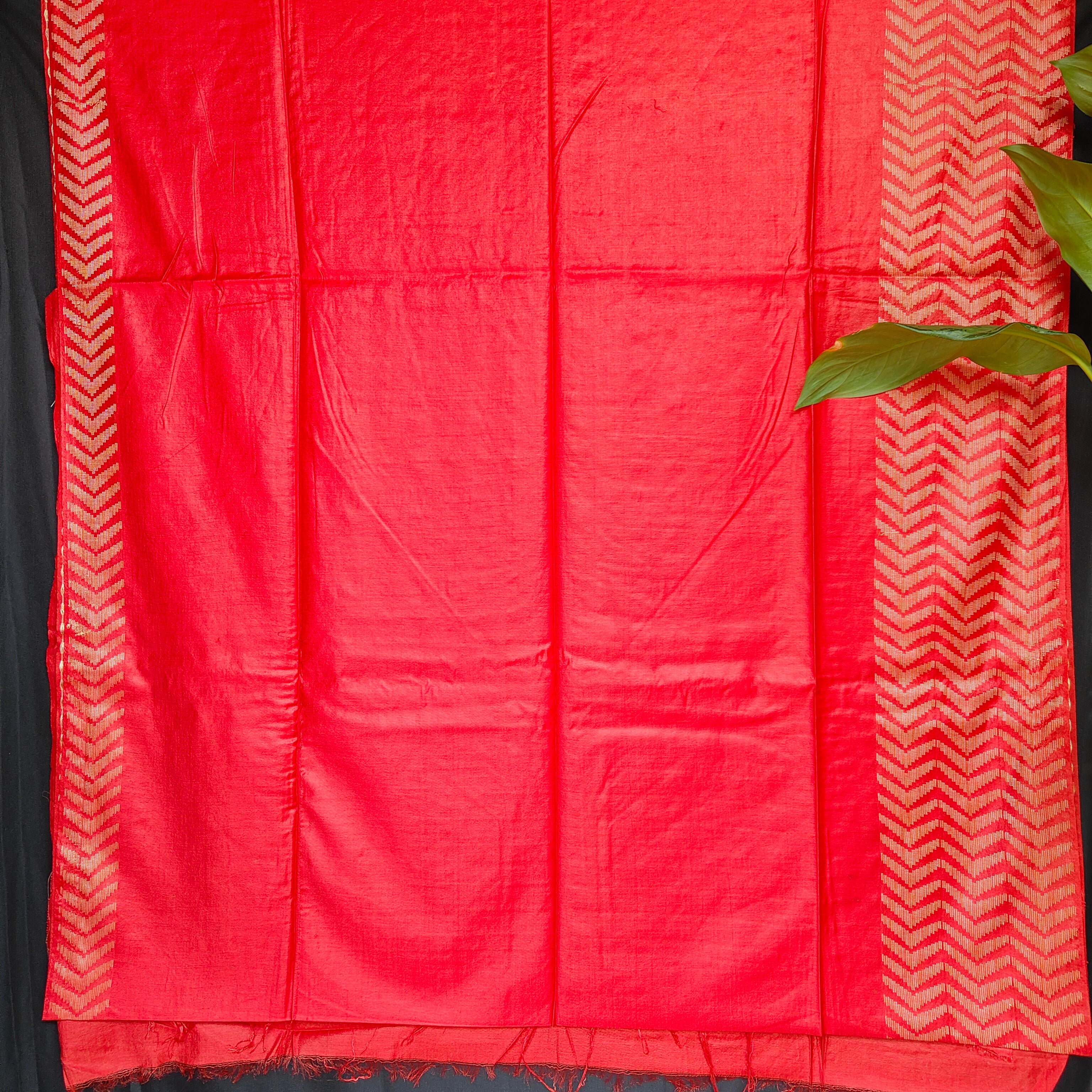 Red fabric with white geometric patterns on a black background