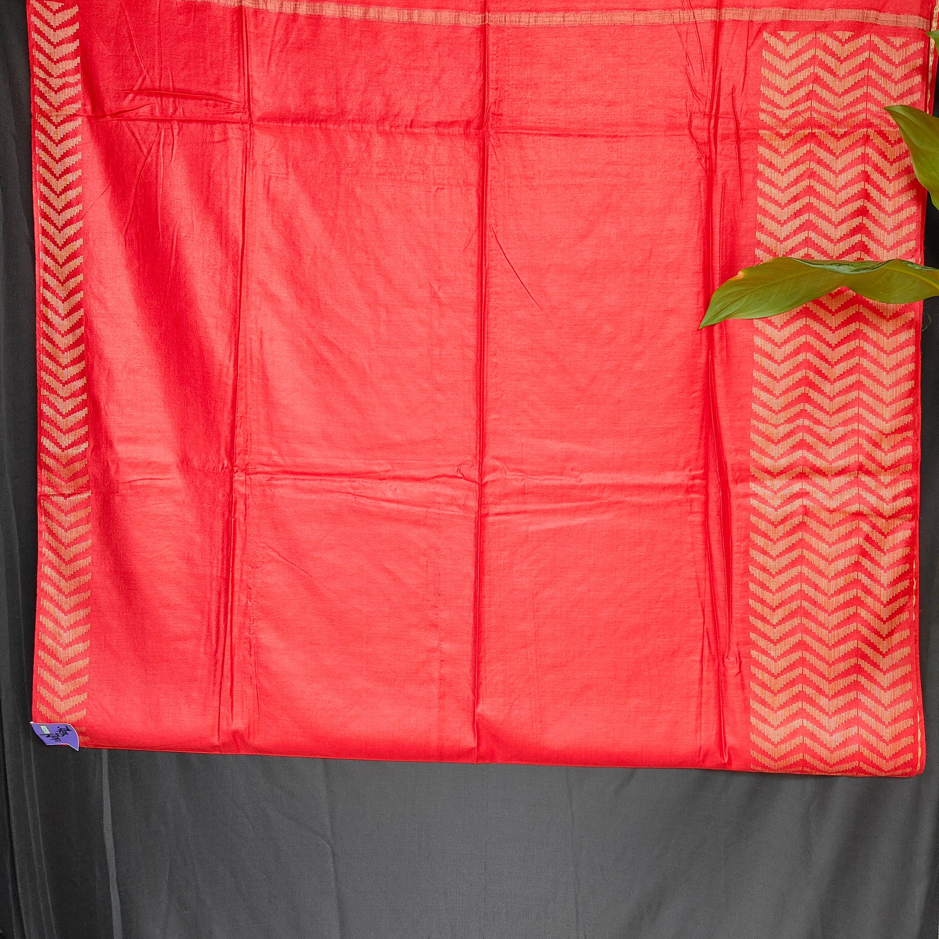 Red fabric with a chevron pattern on a gray background