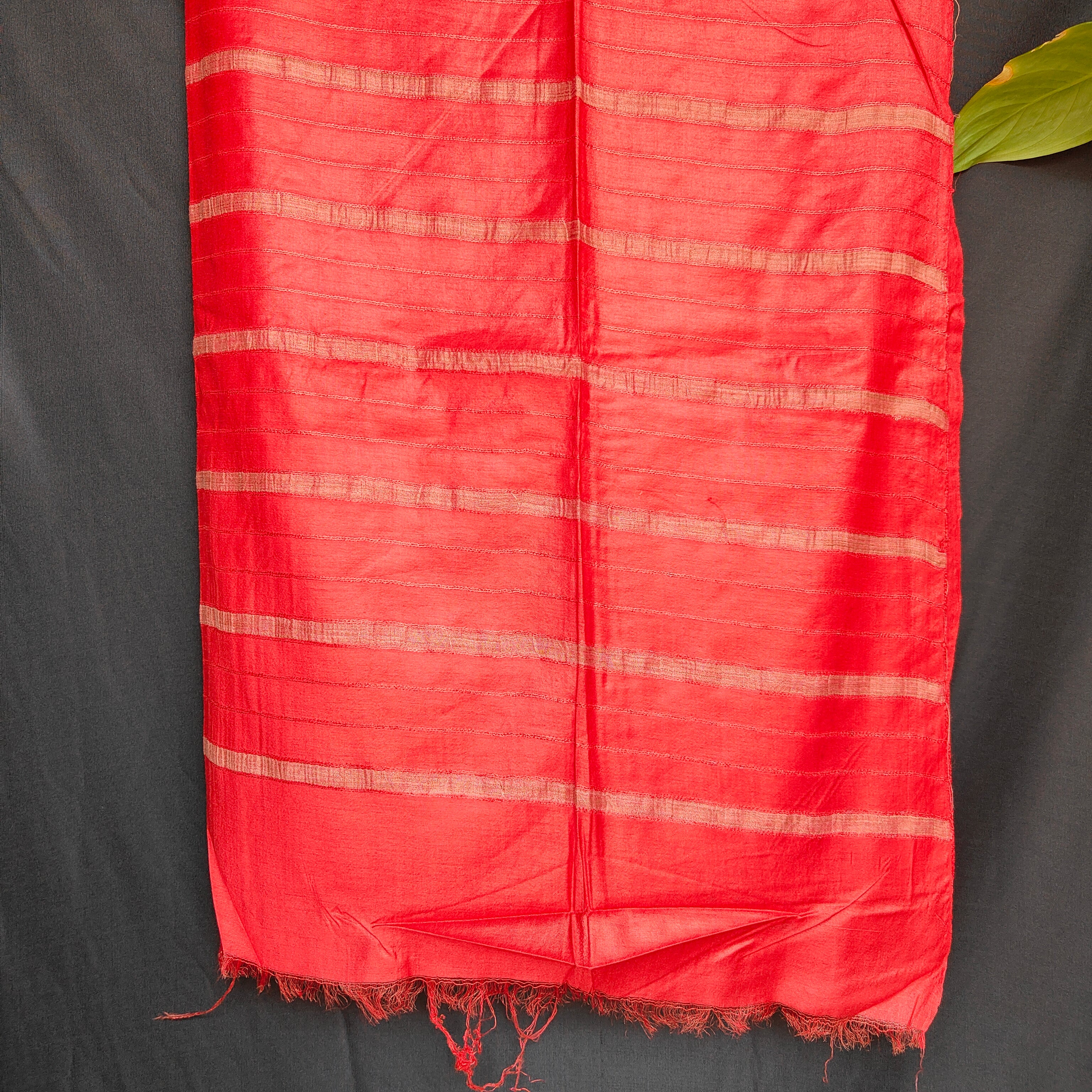 Red fabric with white stripes on a dark background
