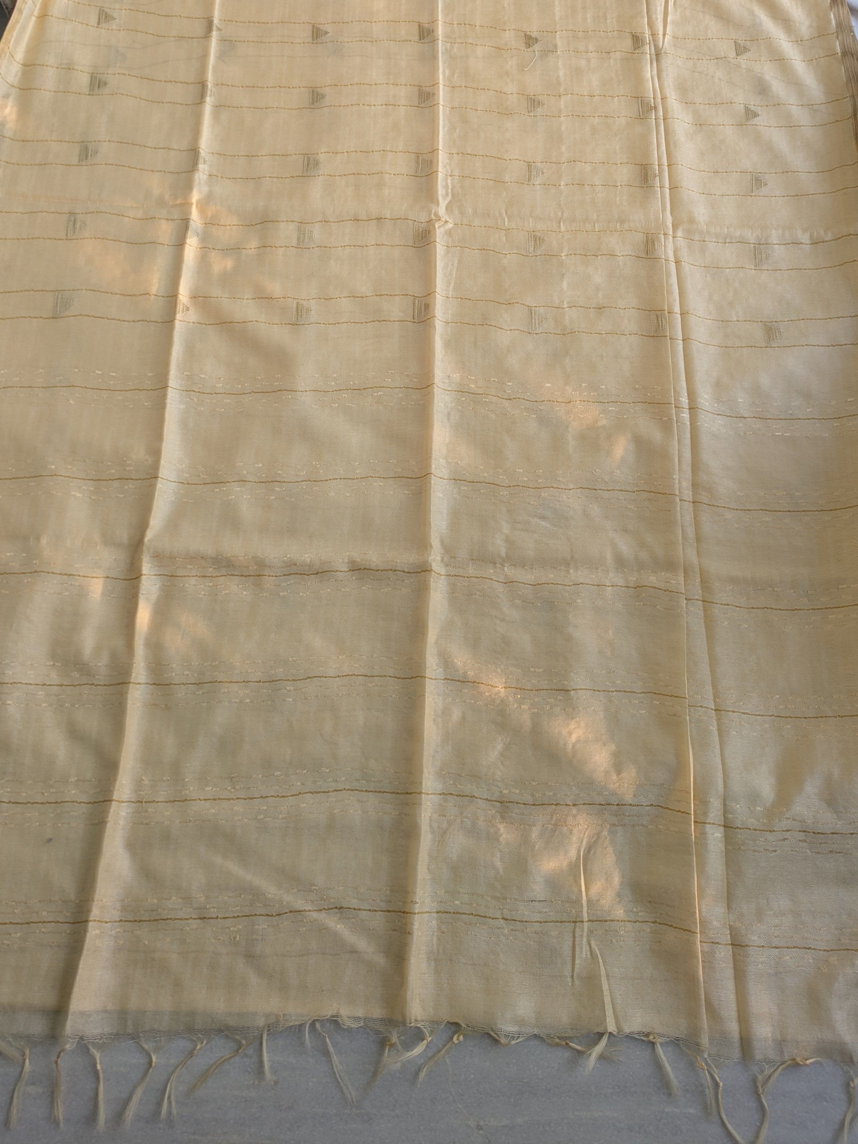 Beige fabric with fringes on a plain background