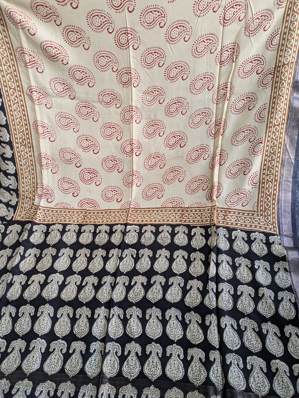 Traditional patterned fabric with paisley design on a white background