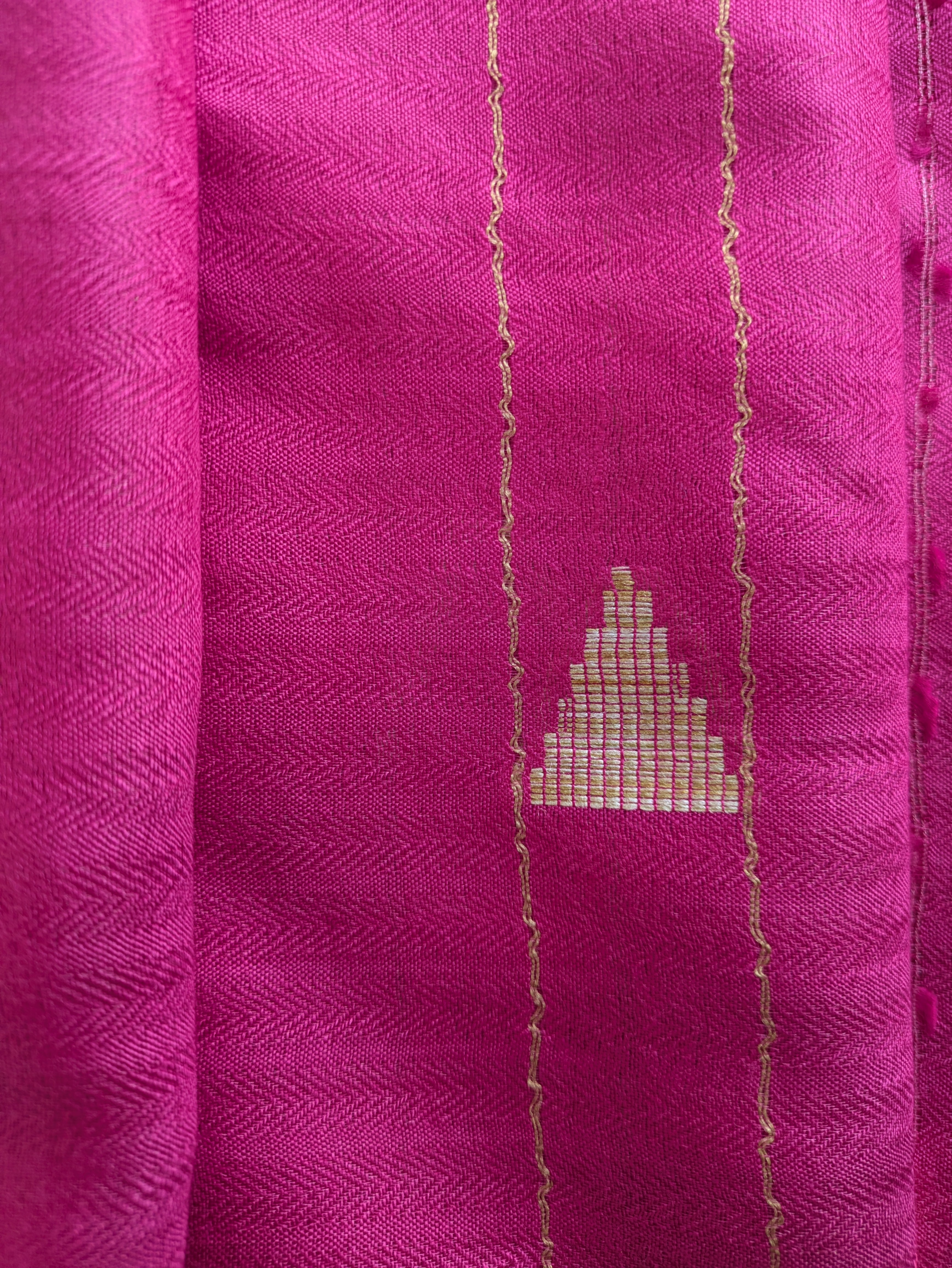 Close-up of a pink fabric with a decorative white pattern