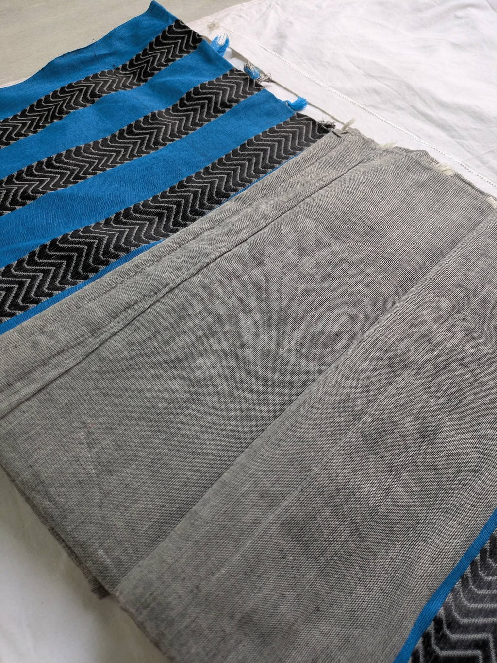 Gray fabric with blue and black pattern on a white background