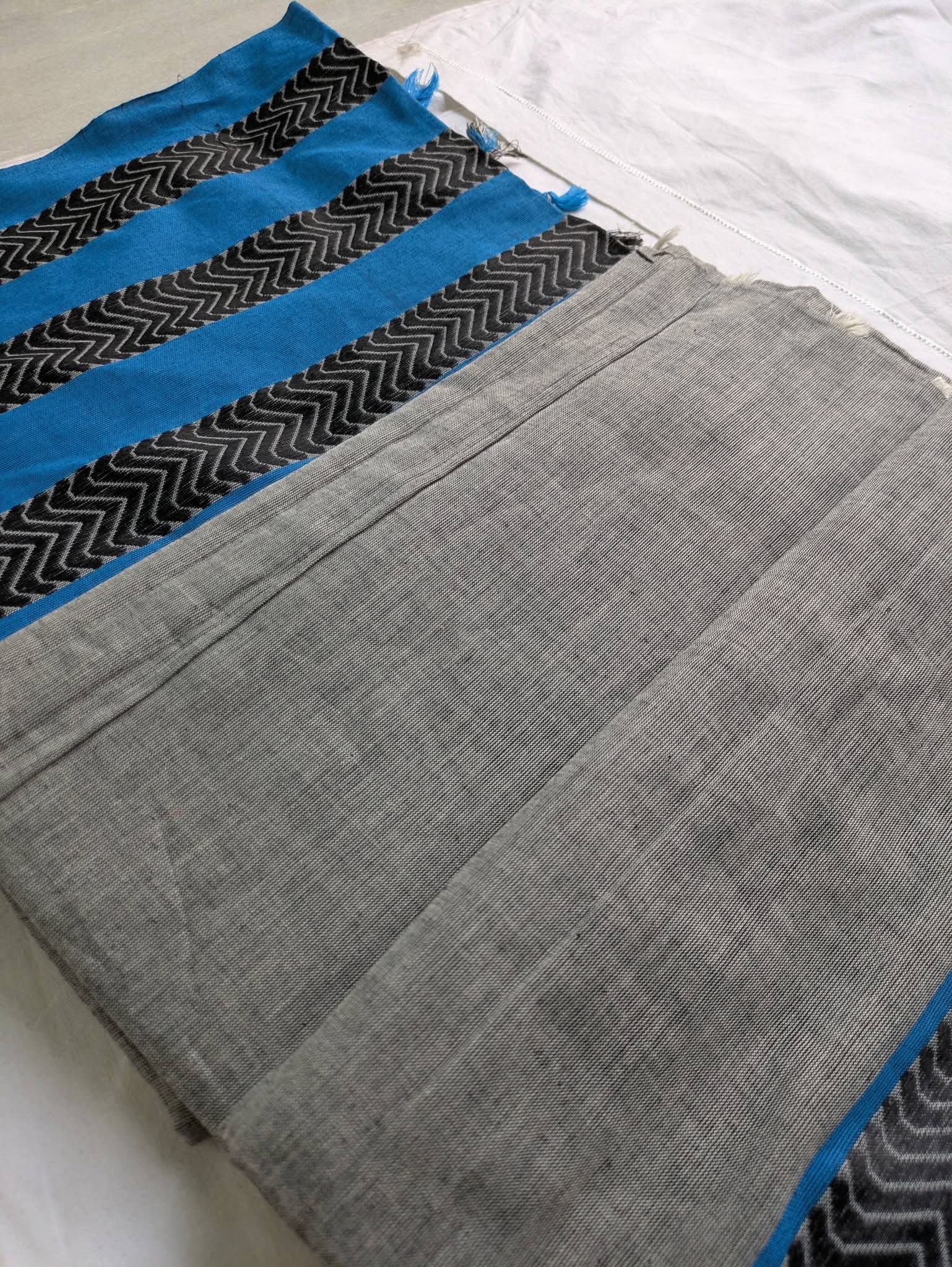 Gray fabric with blue and black pattern on a white background