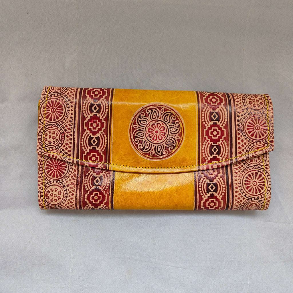 Yellow wallet with red and brown patterns on a white background