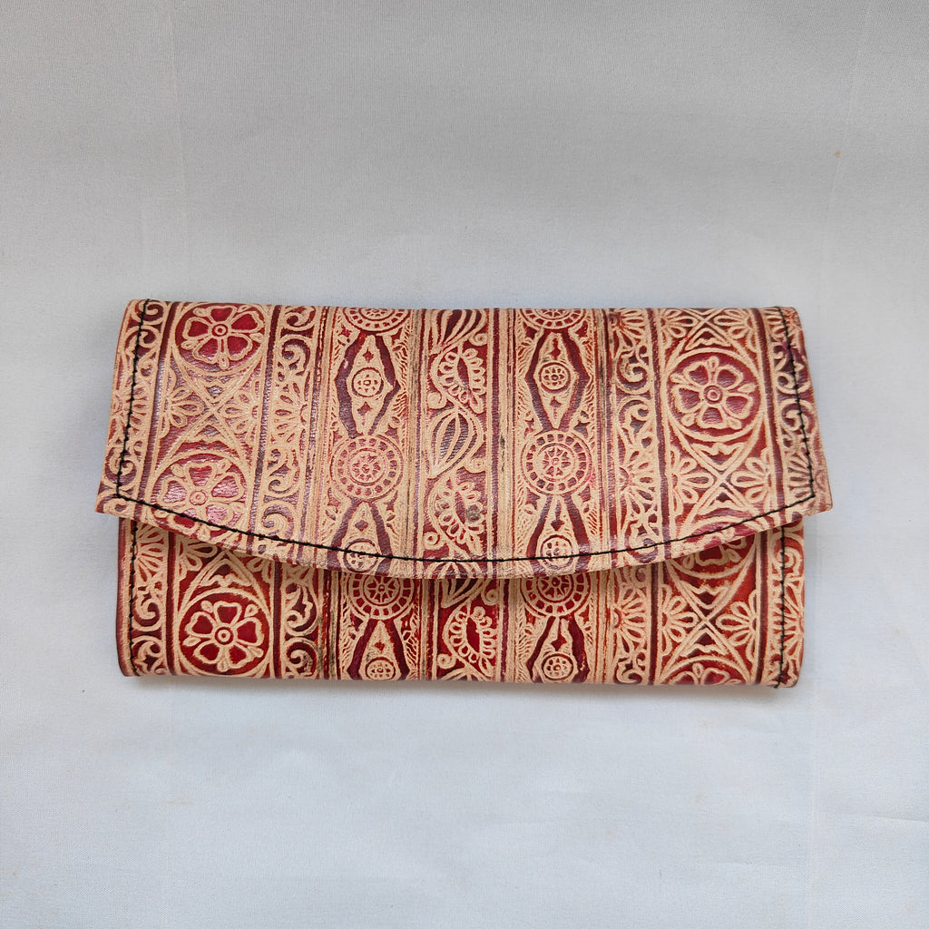 Foldable clutch with red and beige pattern on a light gray background