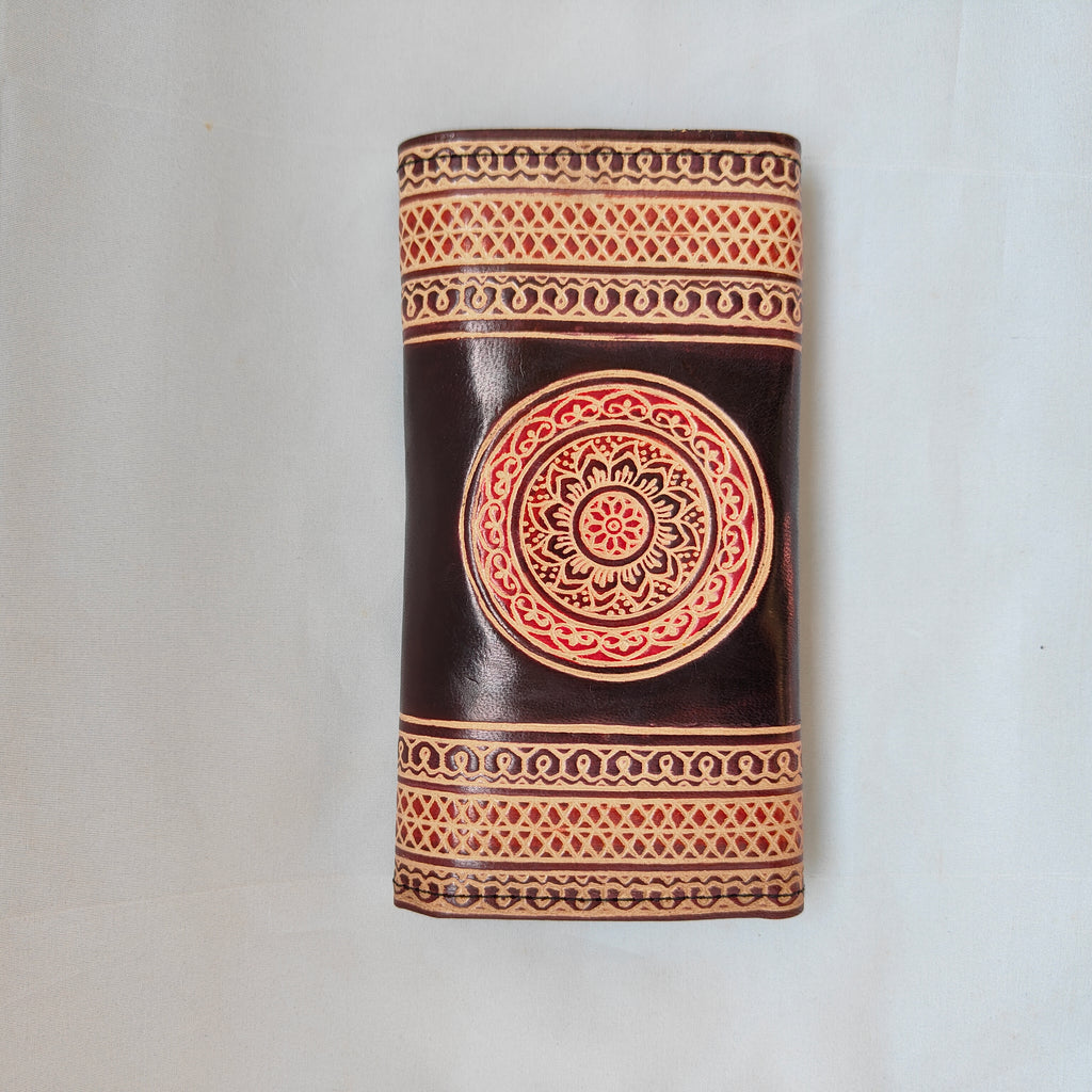 Decorative cylindrical object with intricate patterns on a white background