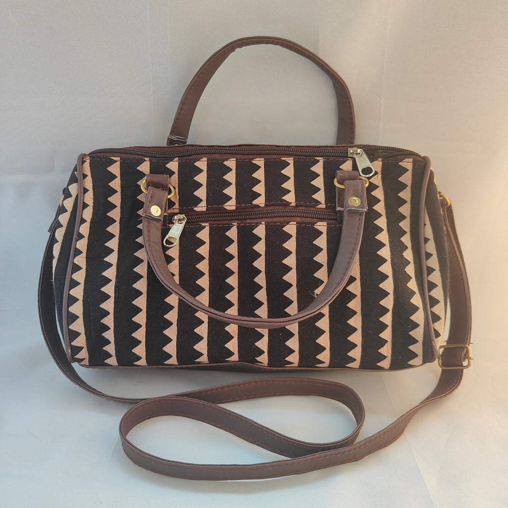 Patterned handbag with a strap on a white background