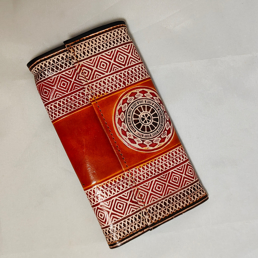 Brown leather wallet with geometric patterns on a light gray background