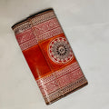 Brown leather wallet with geometric patterns on a light gray background