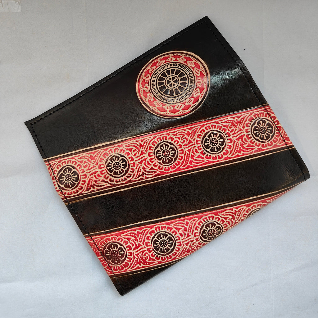 Decorative black and red patterned pouch on a light gray background