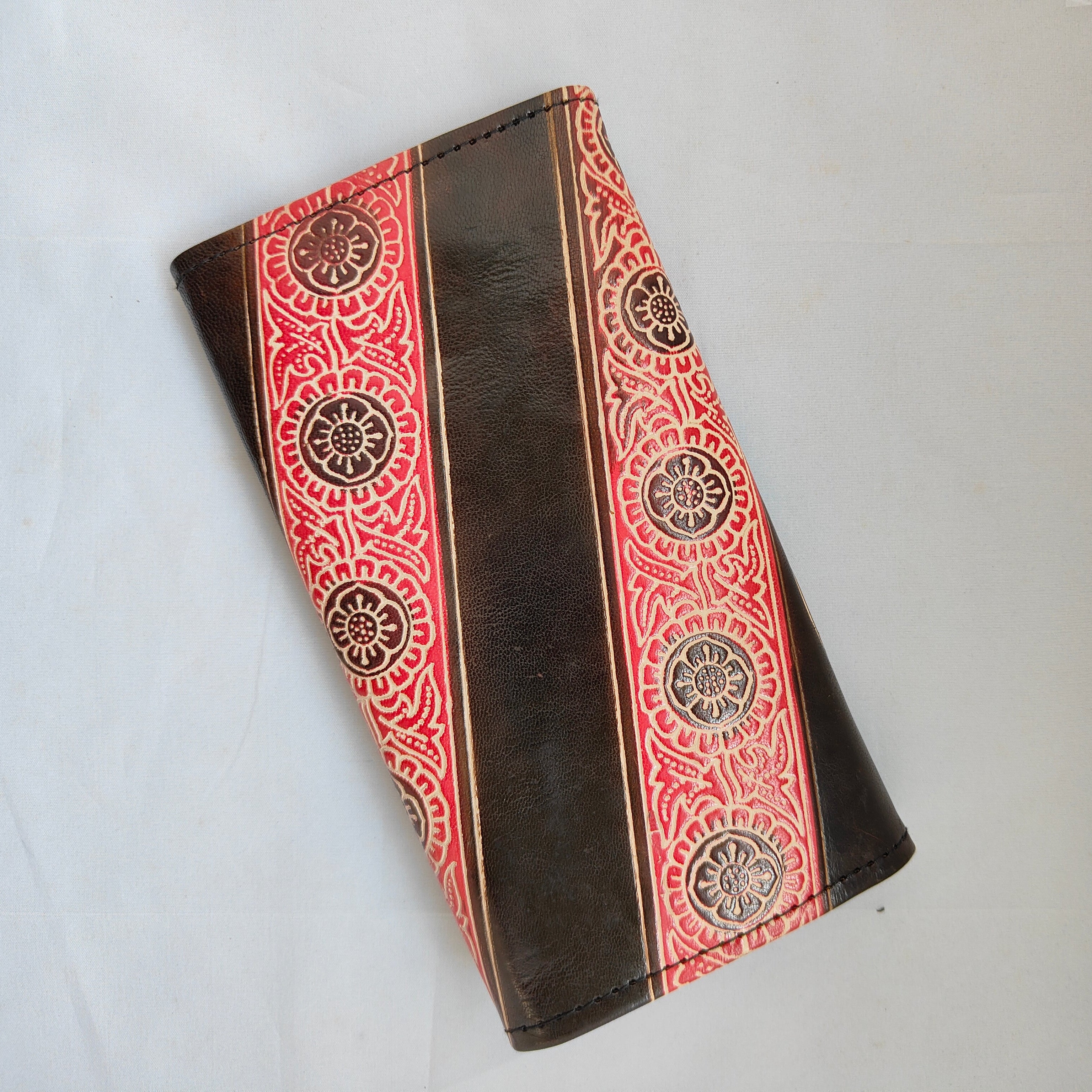 Brown wallet with red and gold pattern on a white background