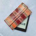 Decorative leather case with intricate patterns on a white surface