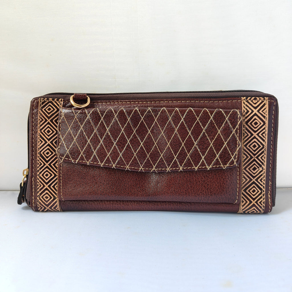 A brown leather zip-around wallet with a diamond-quilted front pocket, gold-tone hardware, and geometric patterned side panels, photographed against a plain light background.
