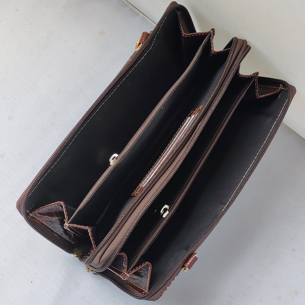 A brown leather multi-compartment wallet or clutch shown open from an overhead angle, revealing multiple zippered pockets and card slots against a light gray background.