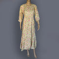 Floral dress on a mannequin against a gray background