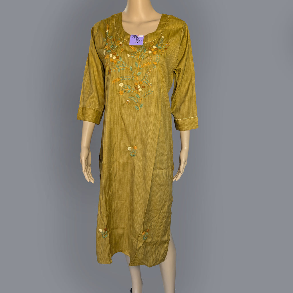Green embroidered dress on a mannequin against a gray background