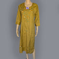 Green embroidered dress on a mannequin against a gray background