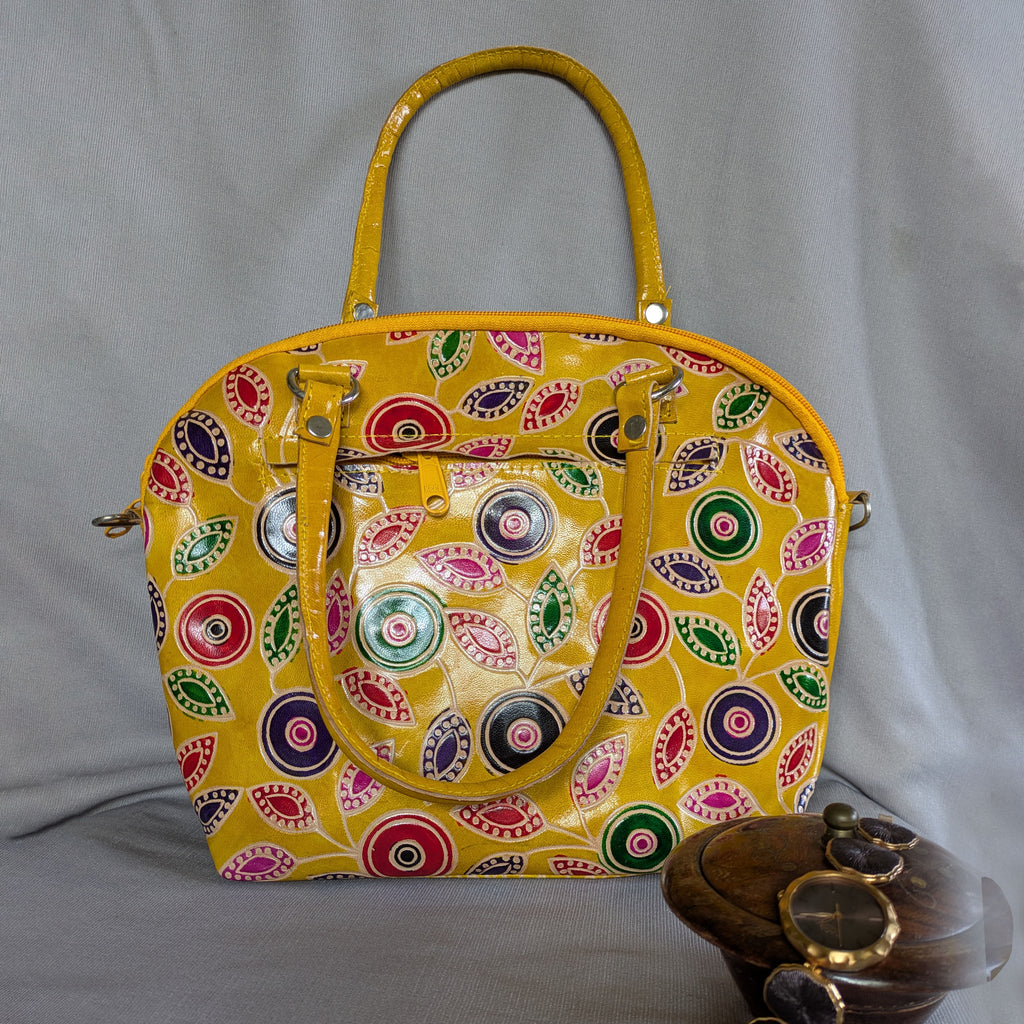 Colorful patterned handbag on a gray background