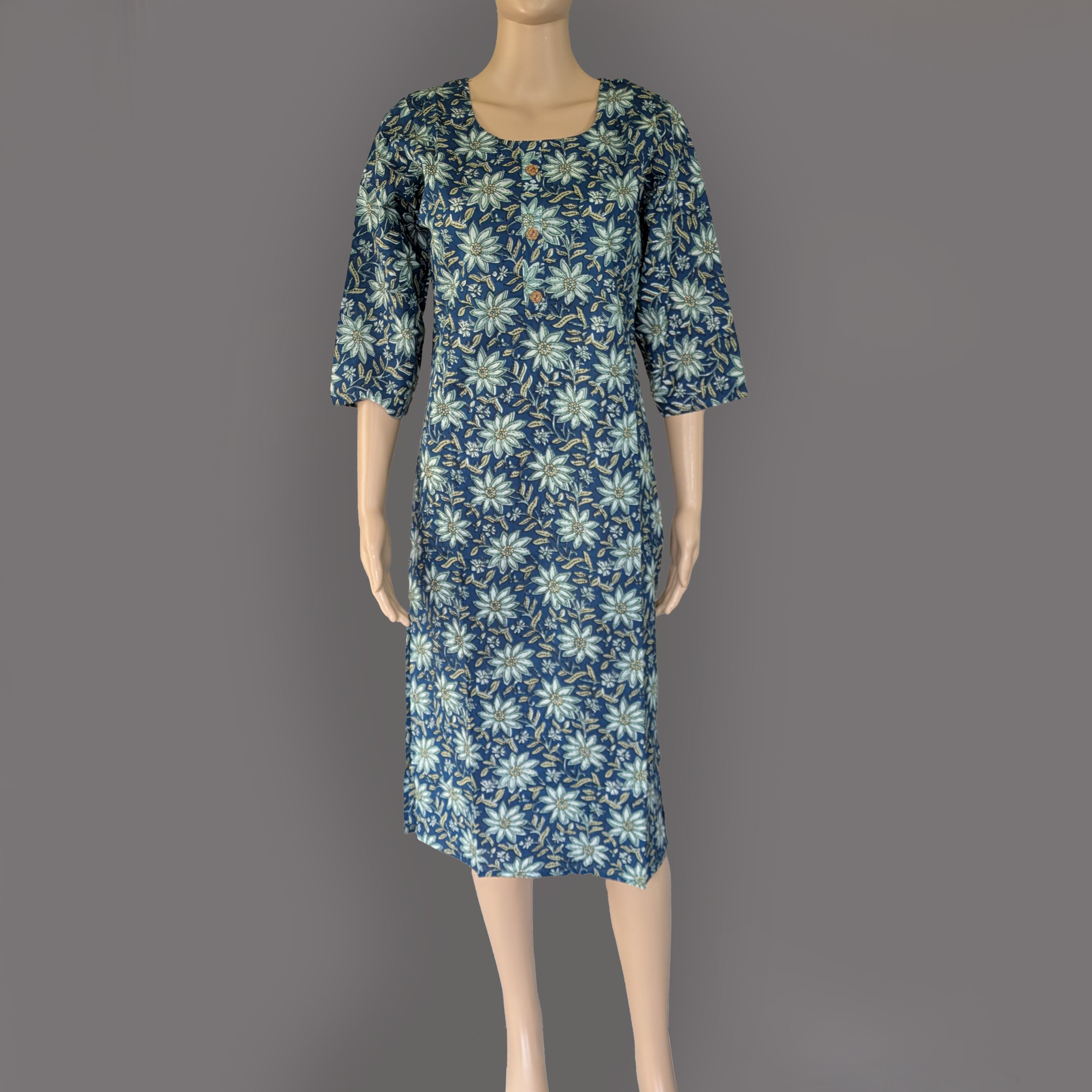 Floral dress on a mannequin against a gray background