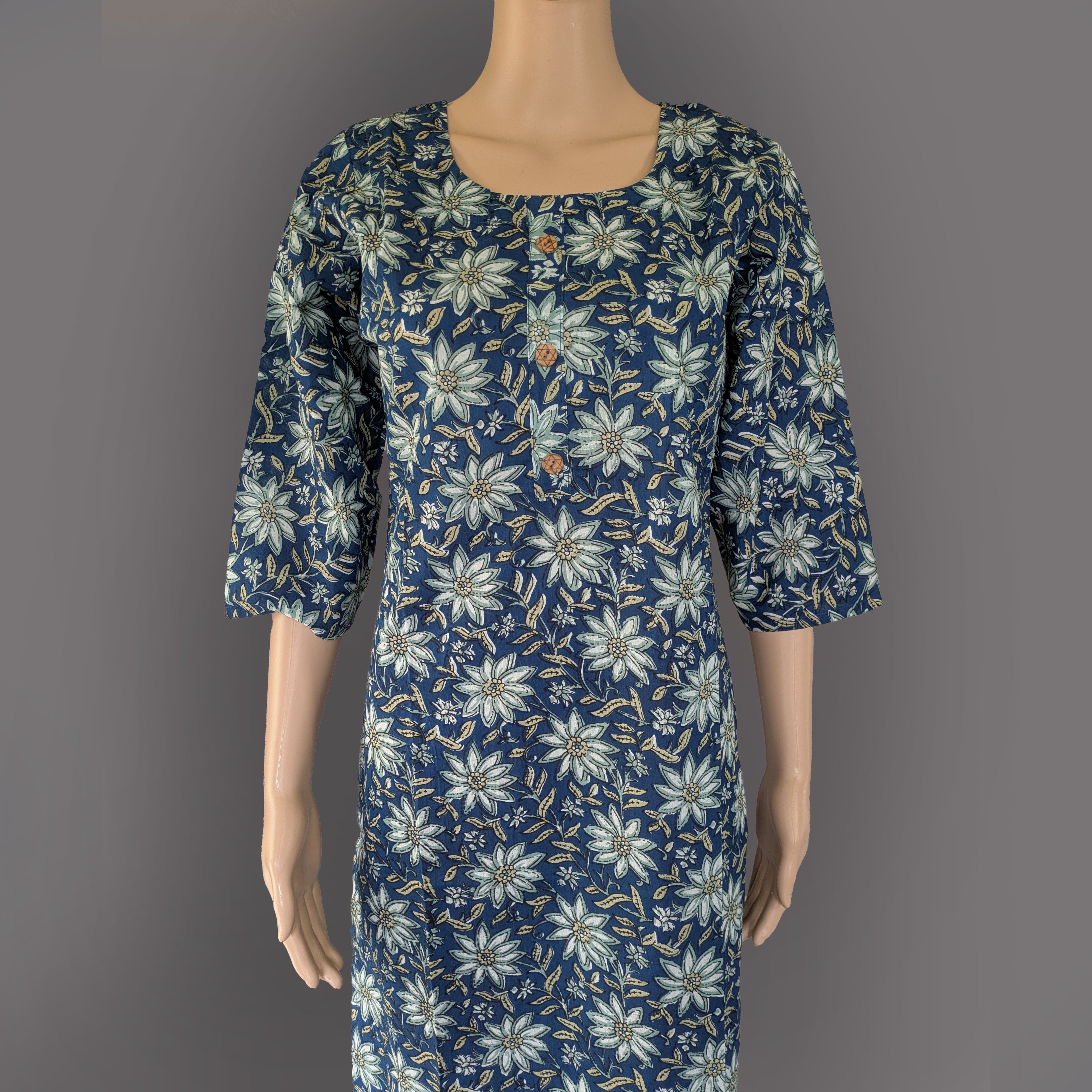Mannequin wearing a blue floral dress against a gray background