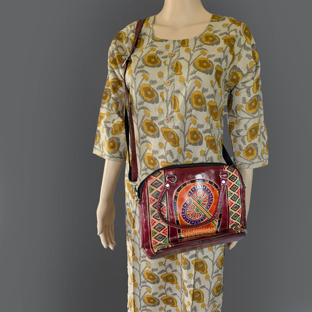 Mannequin wearing a patterned dress with a colorful handbag on a gray background