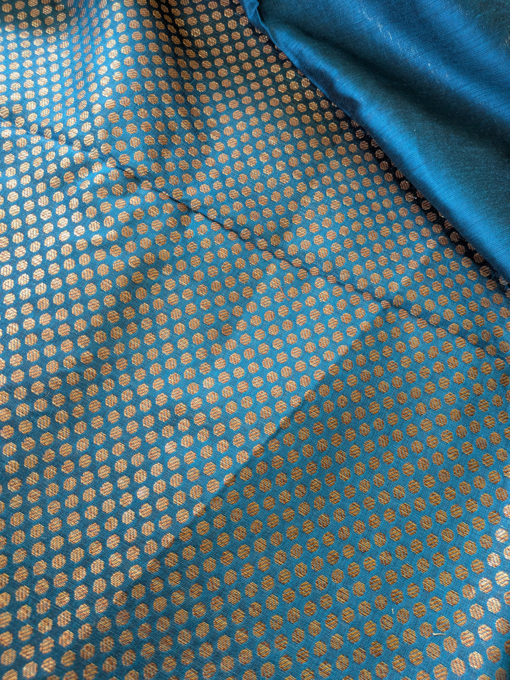 Blue fabric with a subtle pattern, possibly silk or satin