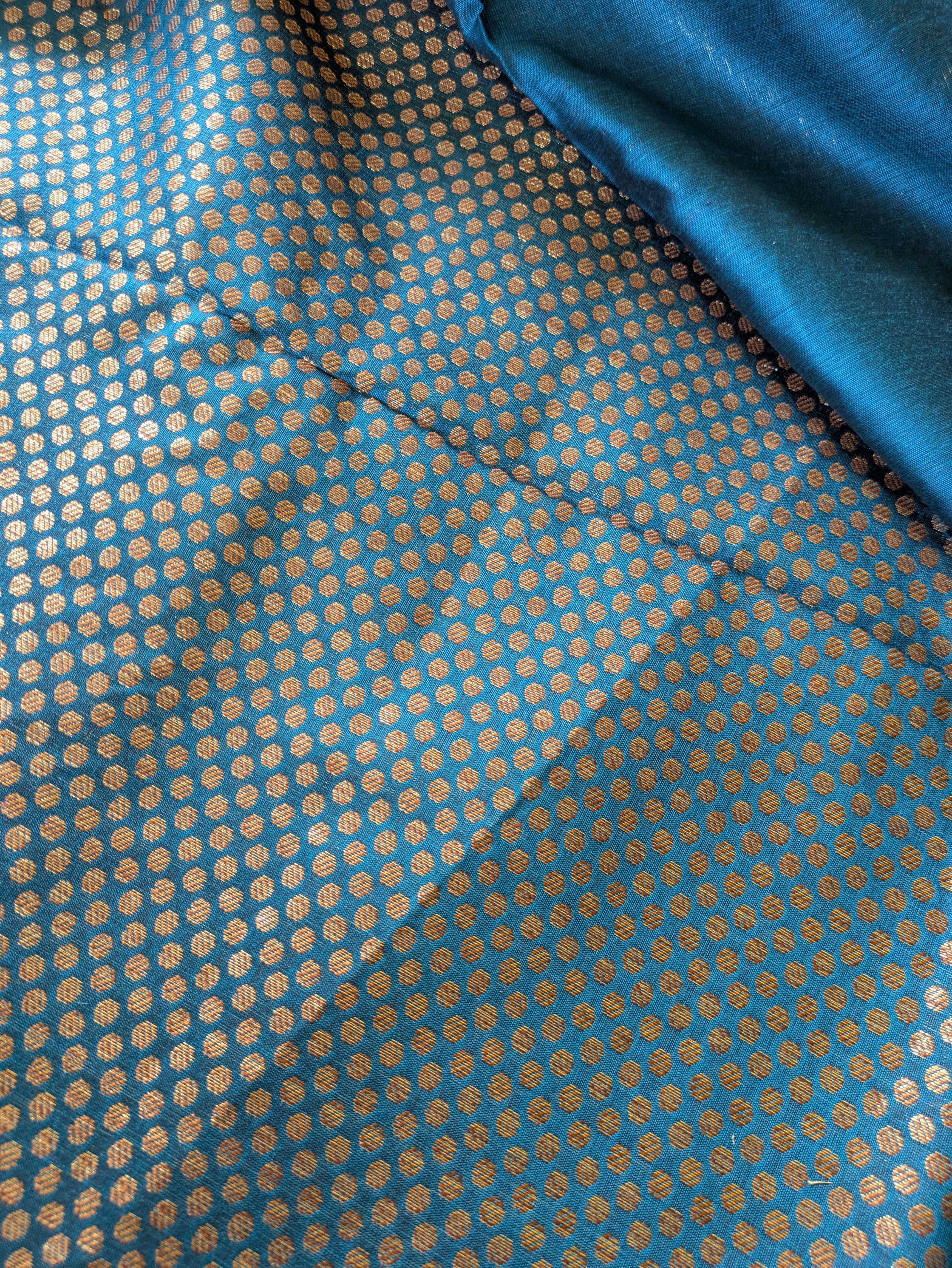 Blue fabric with a subtle pattern, possibly silk or satin