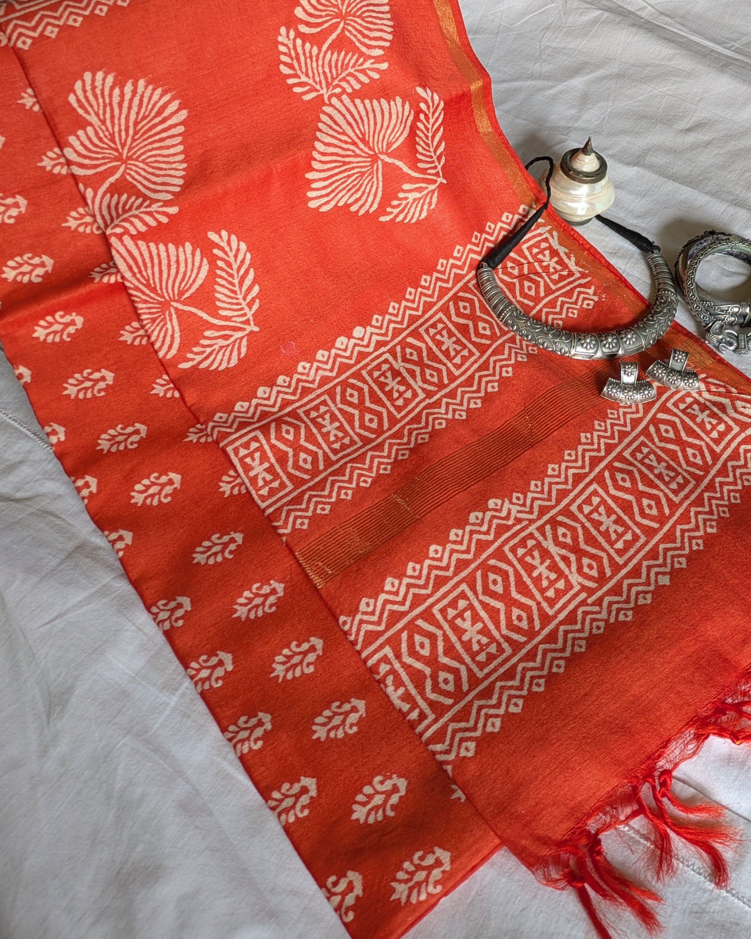 Red fabric with white patterns on a light gray surface