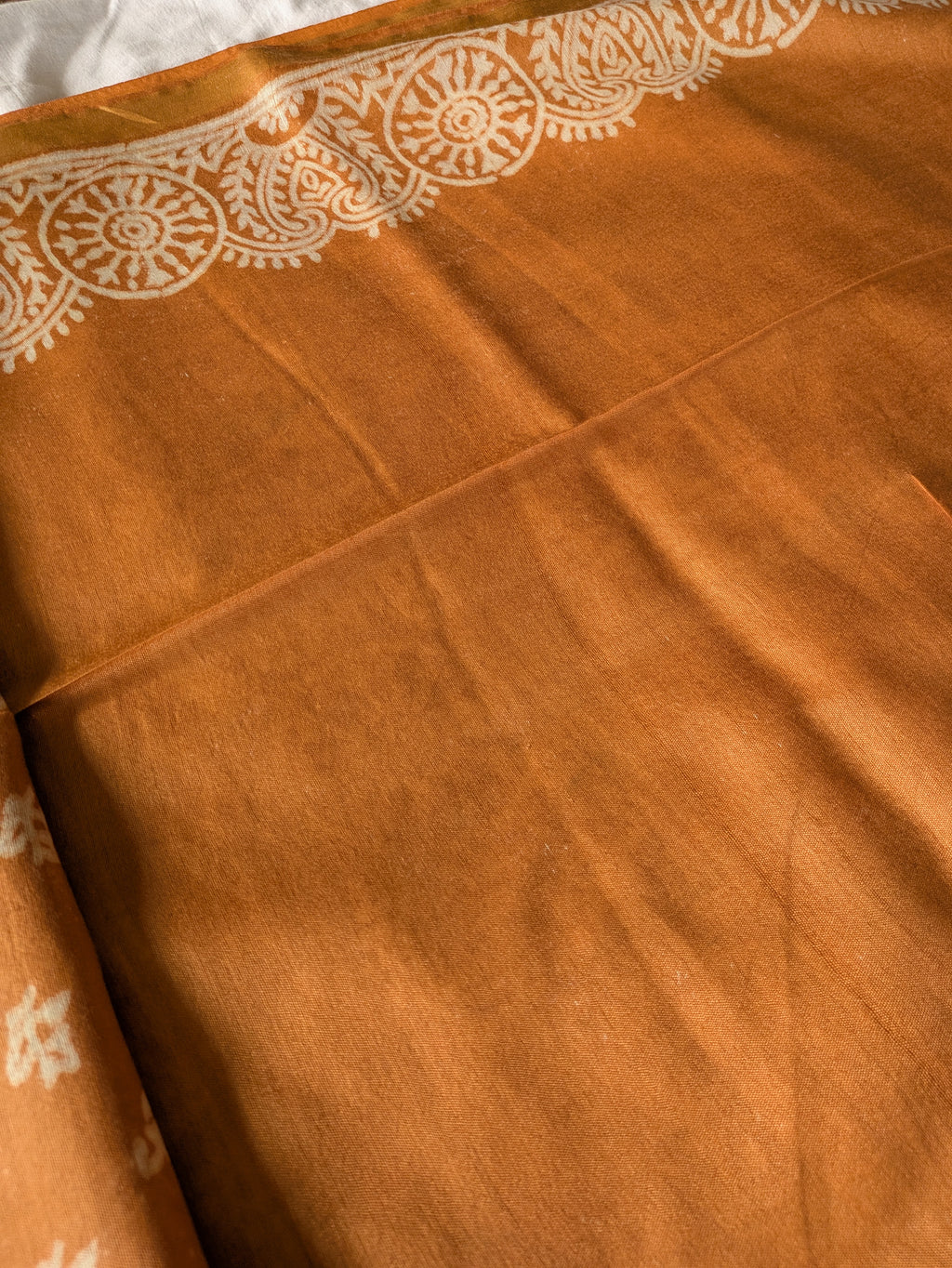Brown fabric with white lace-like pattern
