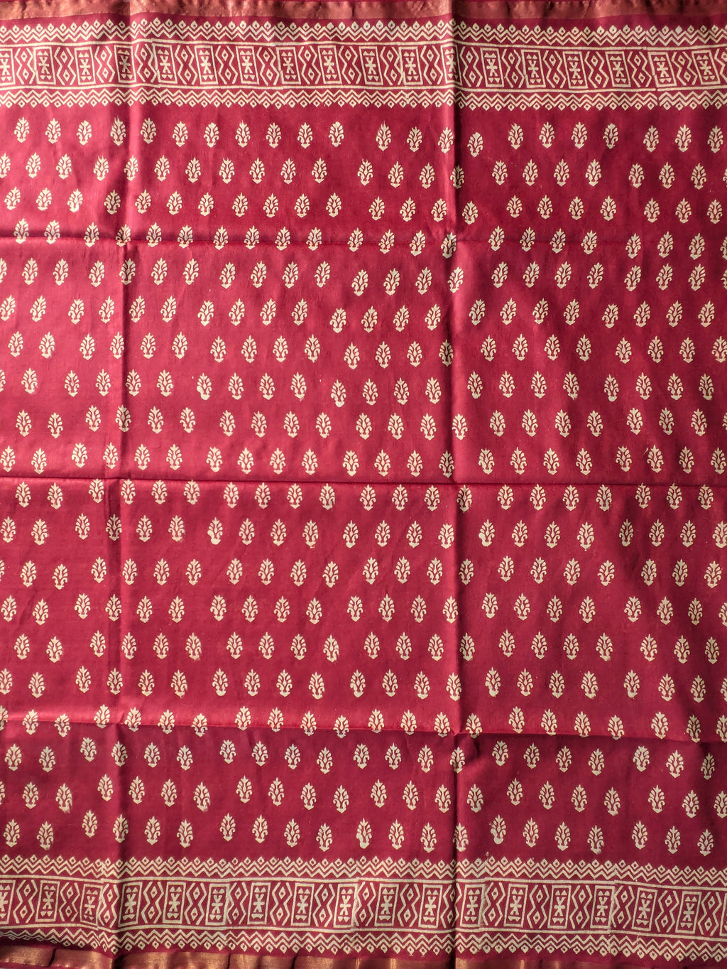 Red fabric with white patterned border