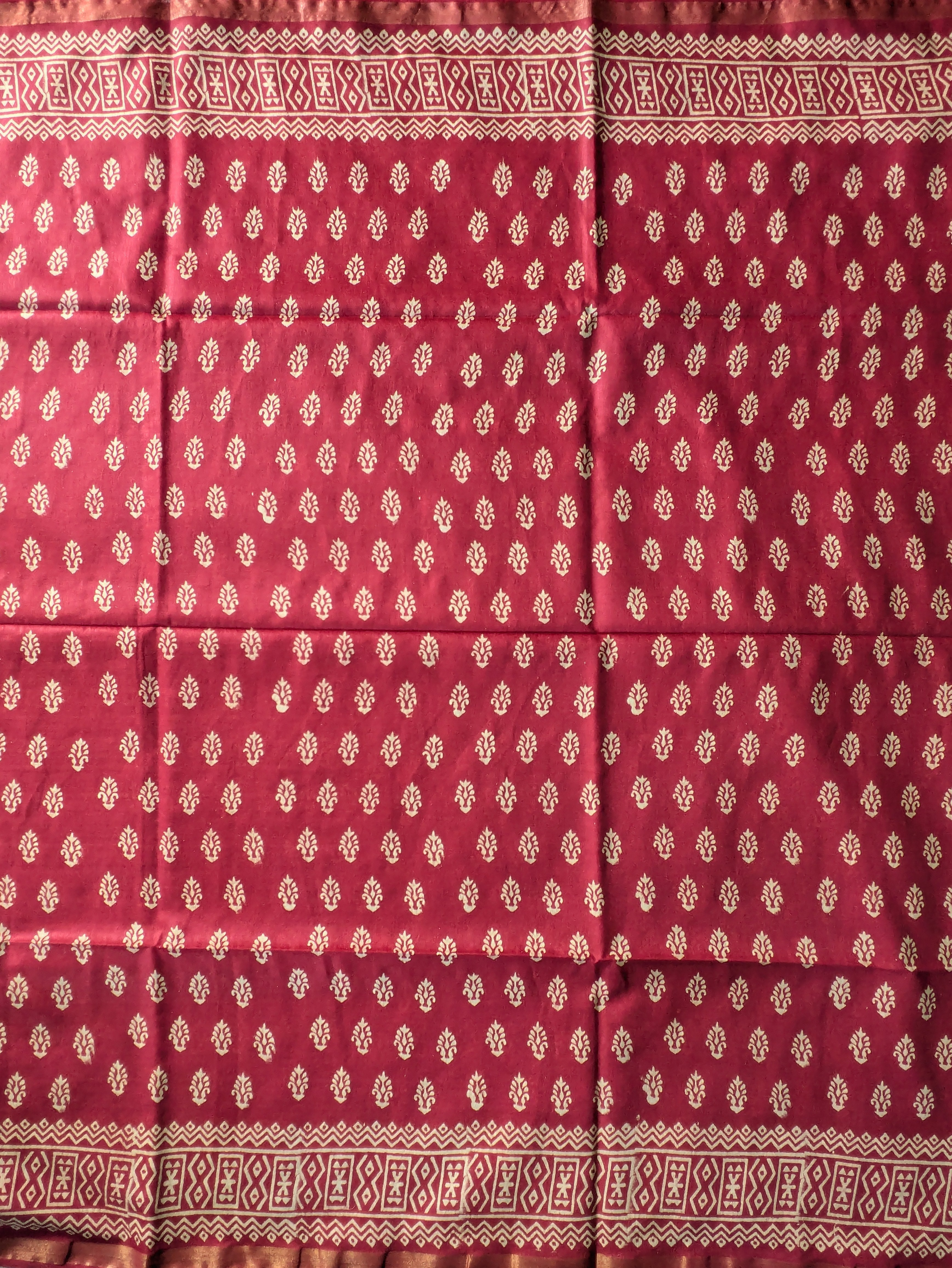 Red fabric with white patterned border