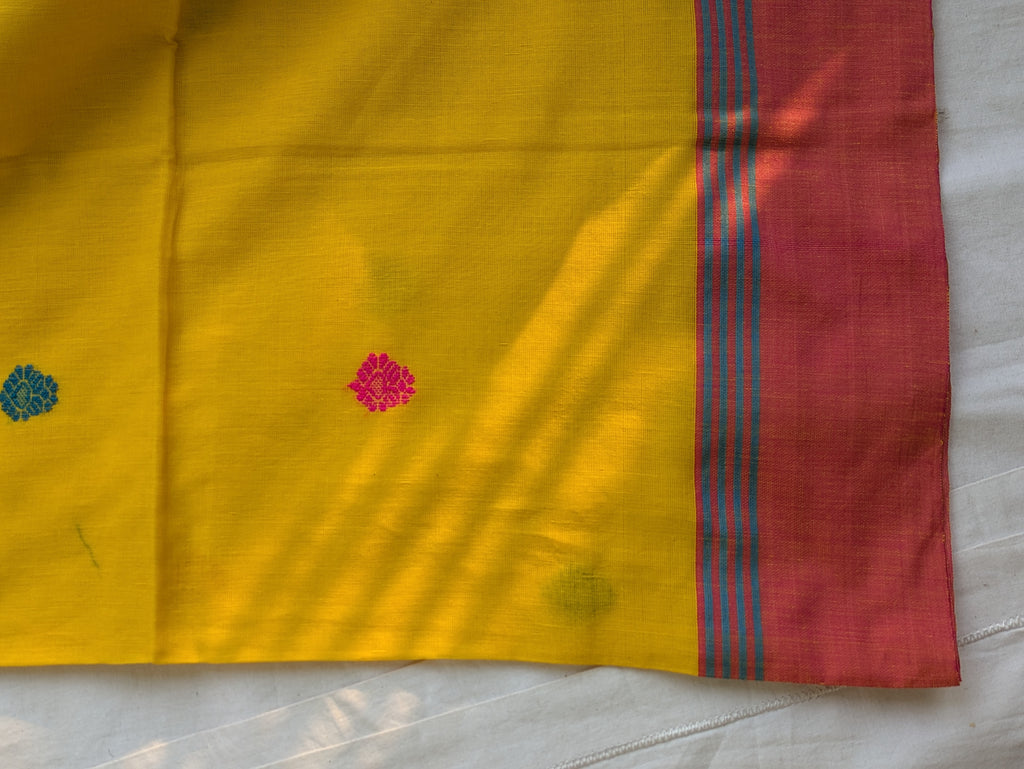 Yellow fabric with red border and floral patterns on a white background