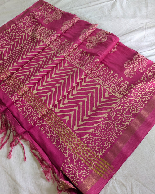 Pink saree with gold patterns on a white background